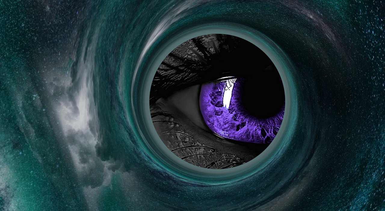 A purple eye in a greyscale face, peering through a hole in the universe