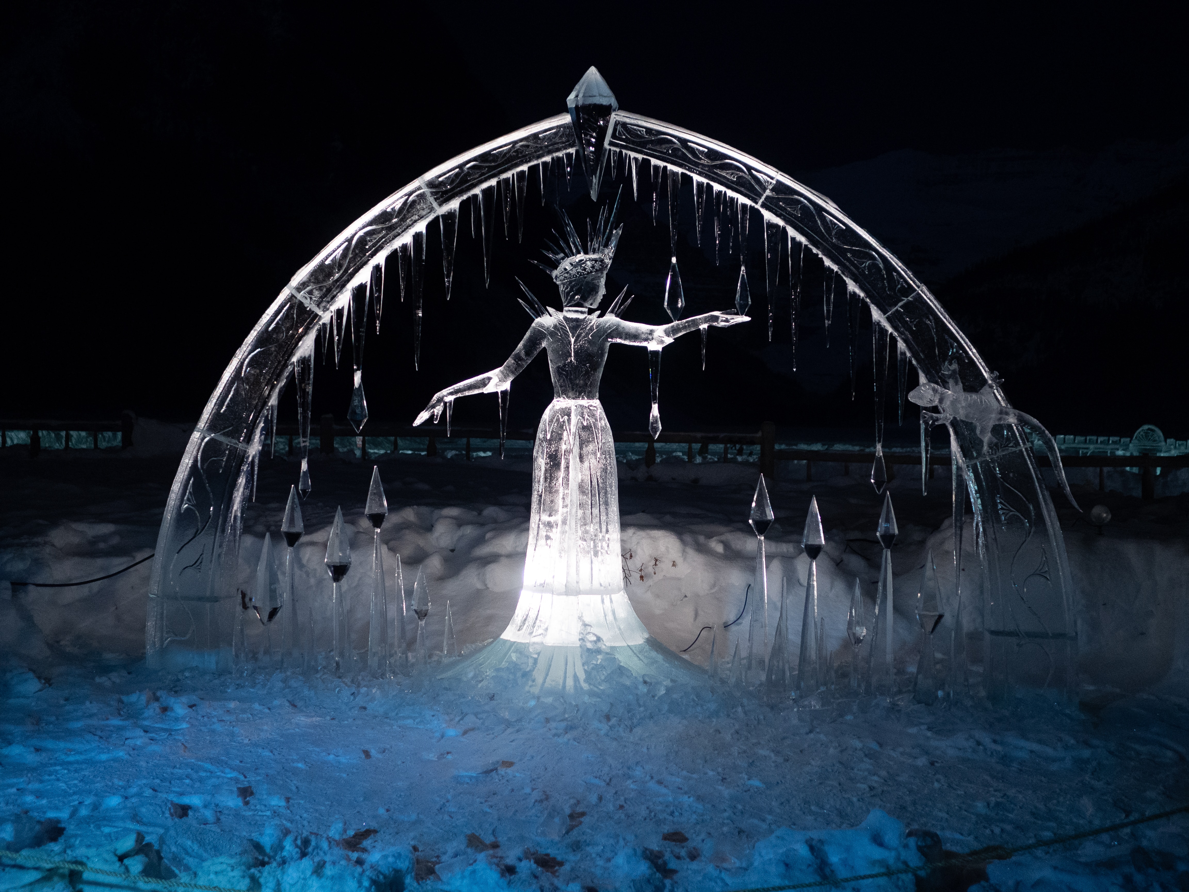 photography of an ice sculpture of a woman under an arch