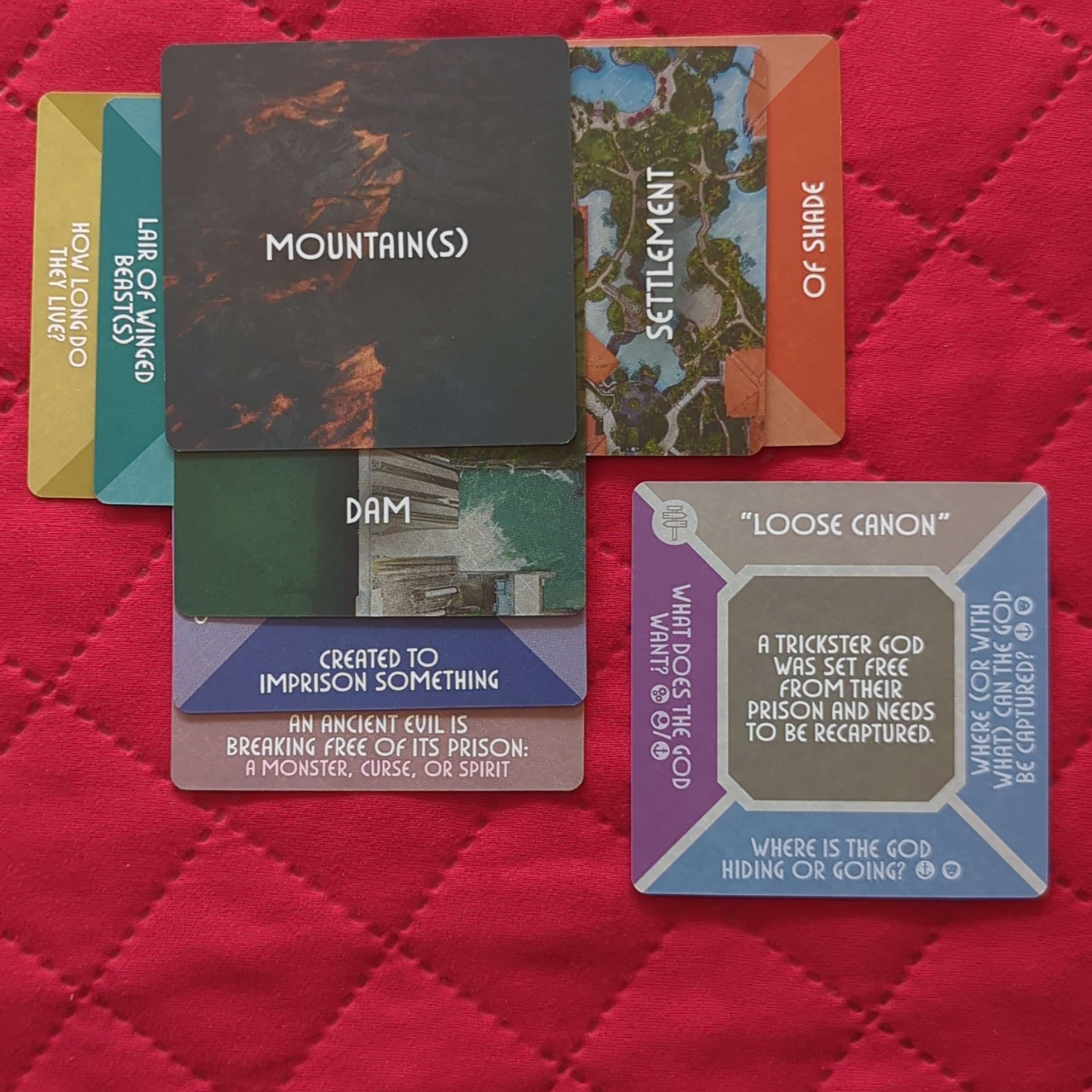 Photo of cards with prompts on them from The Story Engine: Deck of Worlds.
