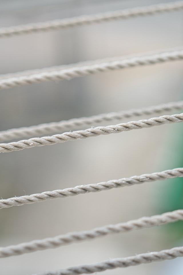 White ropes stretching across a pale background.