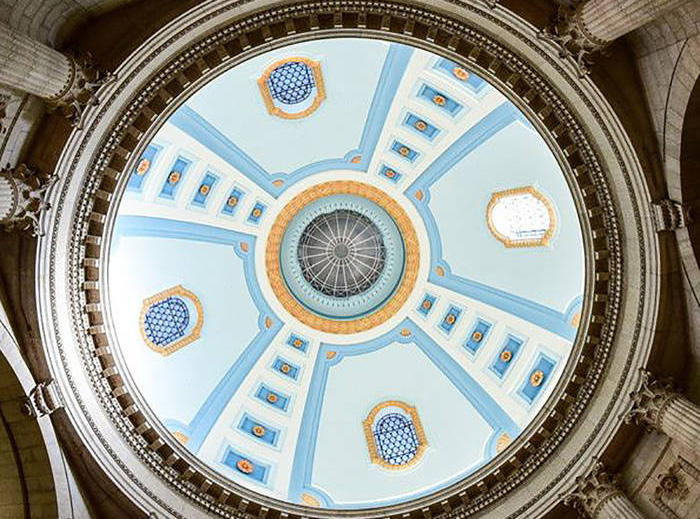 A simple blue and gilded cupola with oculus, viewed from below