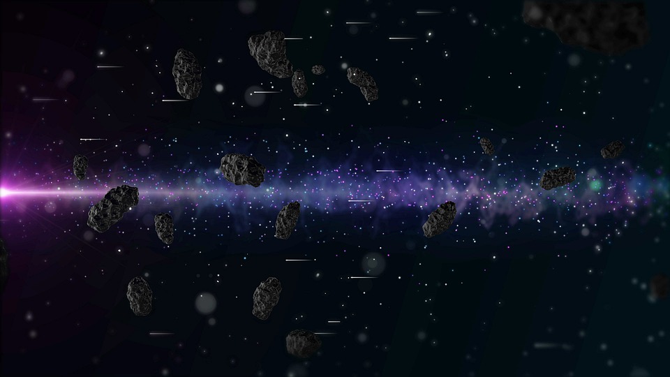 Asteroids in a field, with a pink and purple blast from a pulsar behind