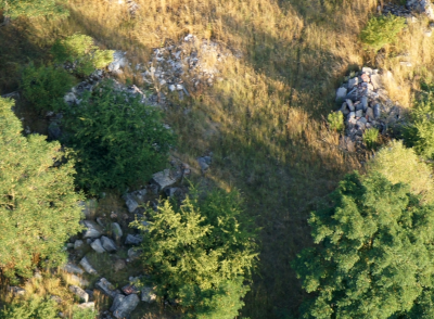 Overhead photo of ruins and debris in a forest