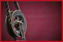Rope pulley on red background.